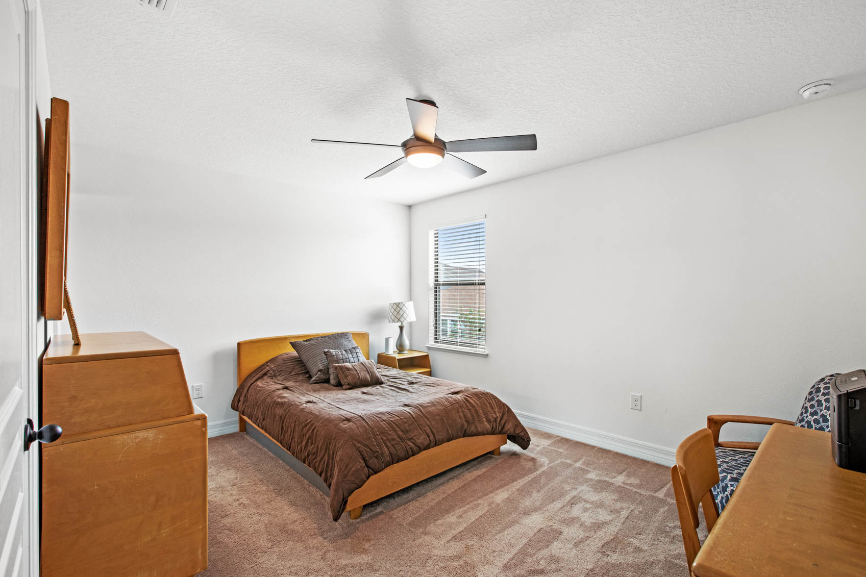 bedroom with brown bed and white walls